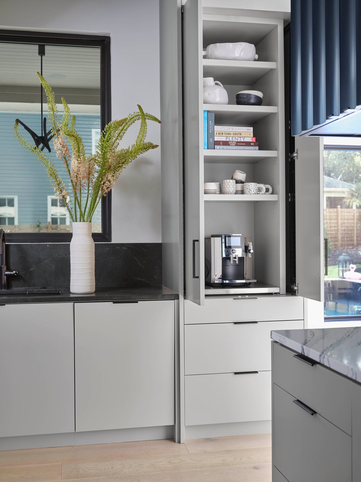 Coffee station at The Dogwood Residence with black stone counters.